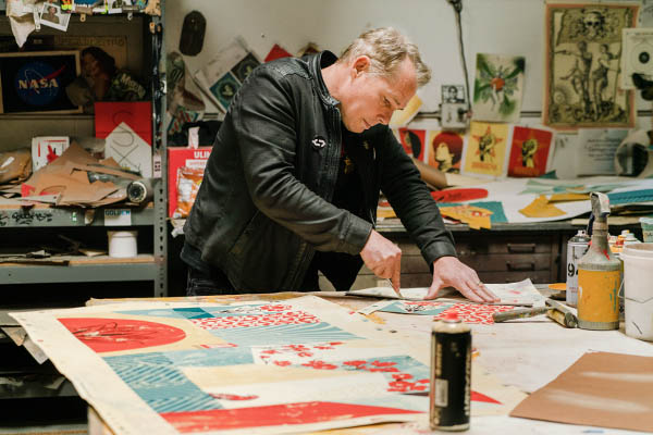 Shepard Fairey painting in his Los Angeles studio